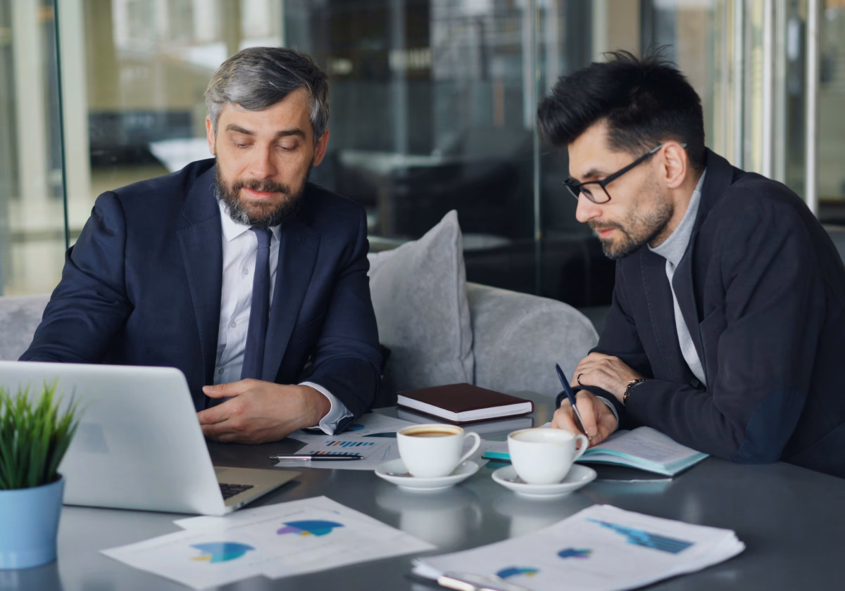 Two people reviewing charts at a desk
